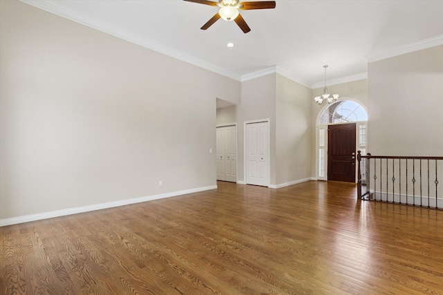 unfurnished room with dark hardwood / wood-style flooring, ceiling fan with notable chandelier, and ornamental molding