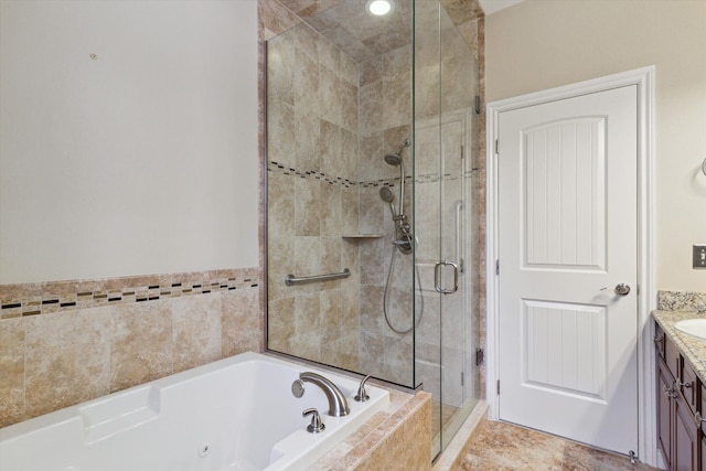 bathroom featuring separate shower and tub and vanity