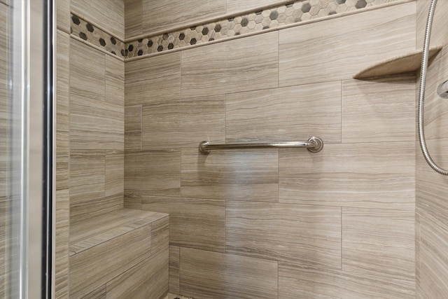 bathroom with a tile shower