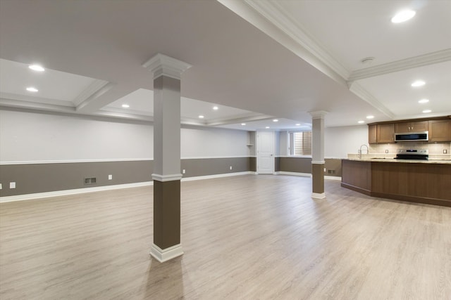 interior space with crown molding, light hardwood / wood-style floors, and sink