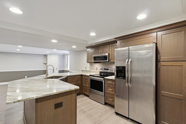 kitchen featuring appliances with stainless steel finishes, tasteful backsplash, sink, ornamental molding, and light stone counters