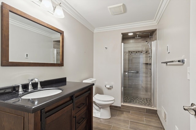 bathroom featuring vanity, toilet, ornamental molding, and a shower with door