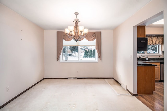 unfurnished dining area with sink and an inviting chandelier