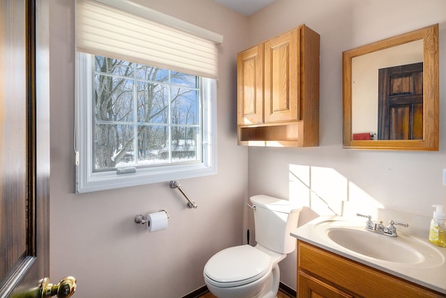 bathroom featuring toilet and vanity