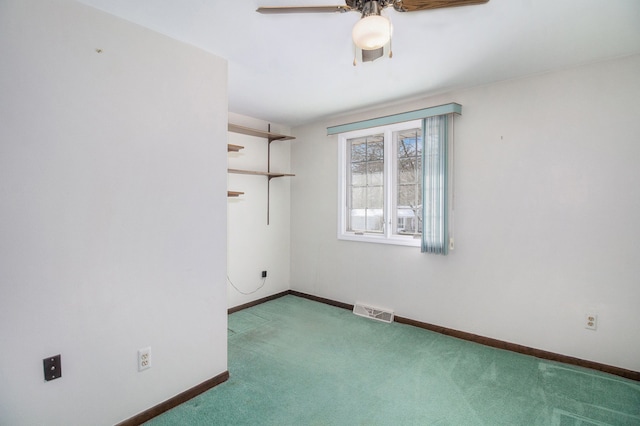 spare room featuring carpet and ceiling fan