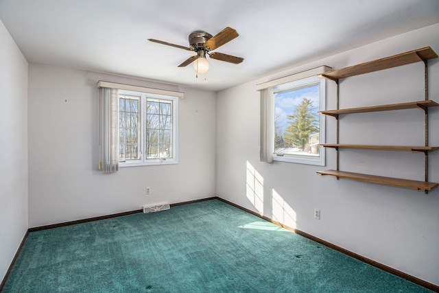 empty room featuring ceiling fan and carpet floors