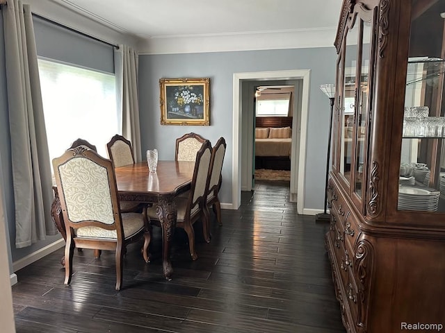 dining area with crown molding and dark hardwood / wood-style floors