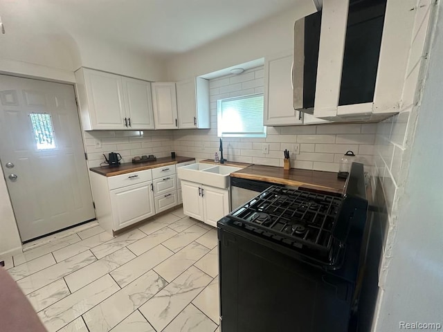 kitchen featuring white cabinets, black gas stove, and wooden counters