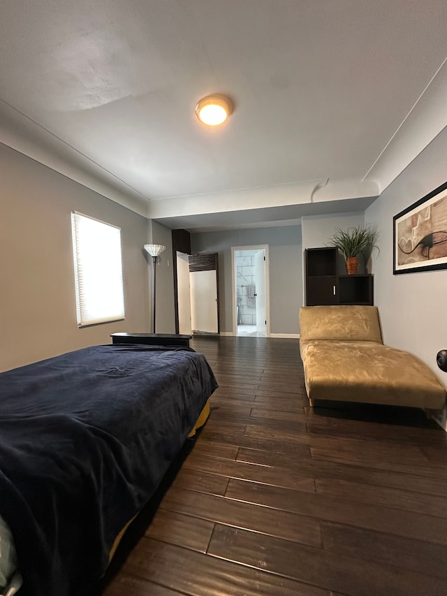 bedroom with dark hardwood / wood-style floors