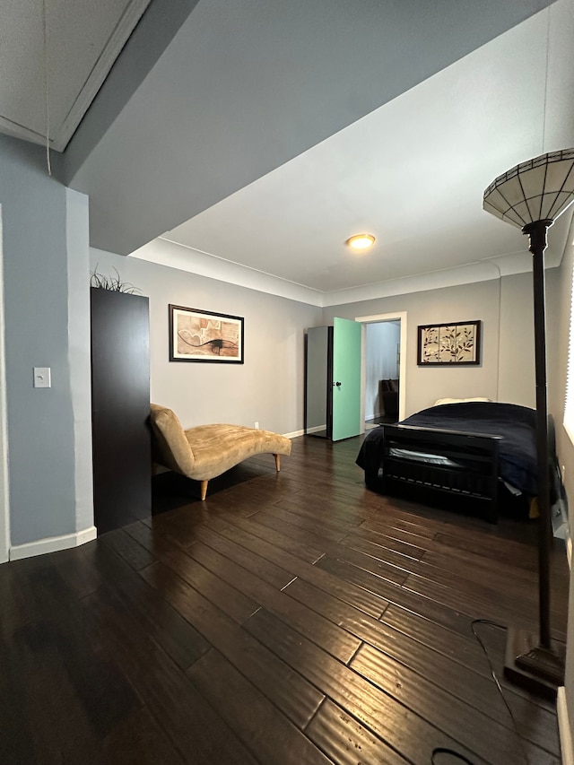 sitting room with crown molding and dark hardwood / wood-style flooring