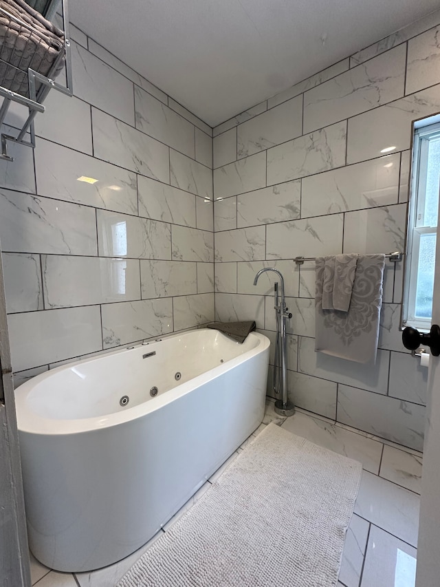 bathroom featuring tile walls and a tub