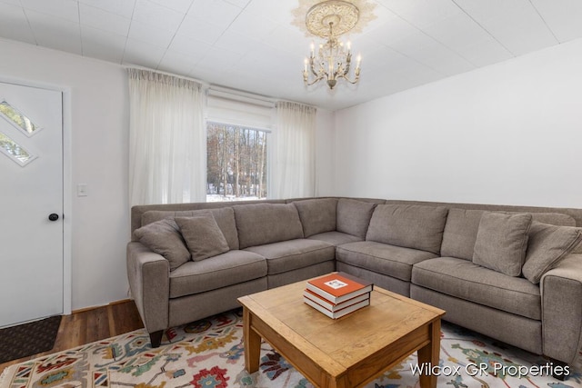 living room featuring an inviting chandelier and wood-type flooring