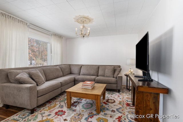 living room featuring light hardwood / wood-style floors and a notable chandelier