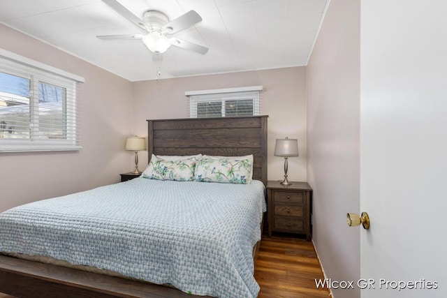 bedroom with ceiling fan and dark hardwood / wood-style floors