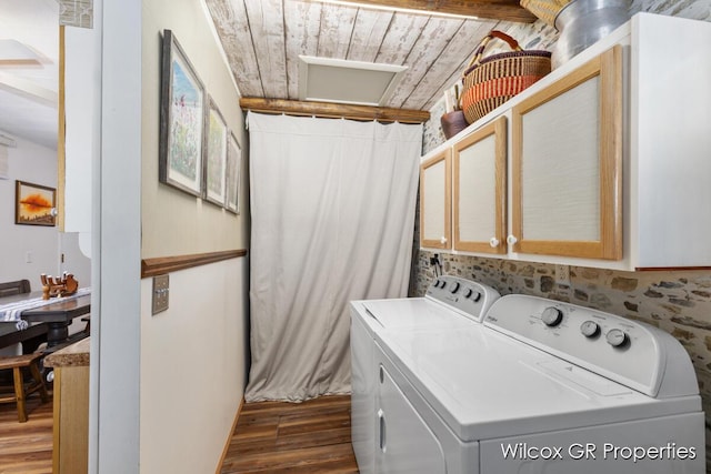 laundry area featuring washing machine and dryer, dark hardwood / wood-style flooring, cabinets, and wooden ceiling