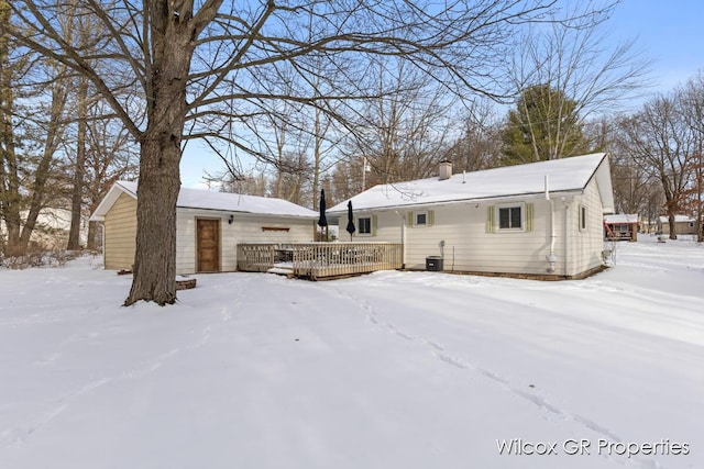 snow covered property featuring central air condition unit and a deck