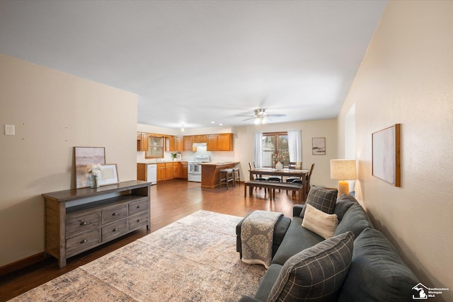 living room with hardwood / wood-style floors and ceiling fan