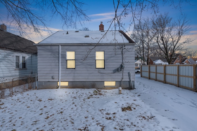 view of snow covered rear of property