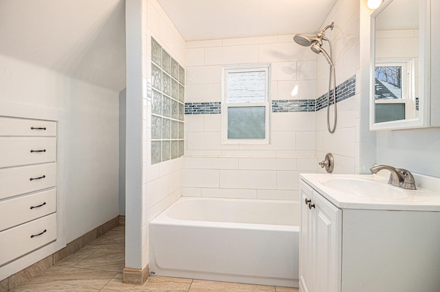 bathroom with vanity and tiled shower / bath