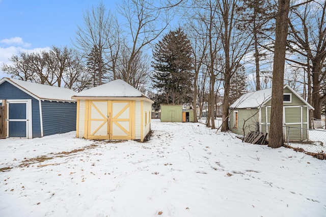 snowy yard with a shed