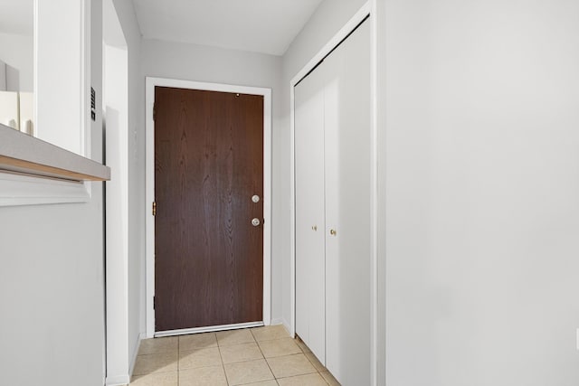 doorway to outside with light tile patterned floors