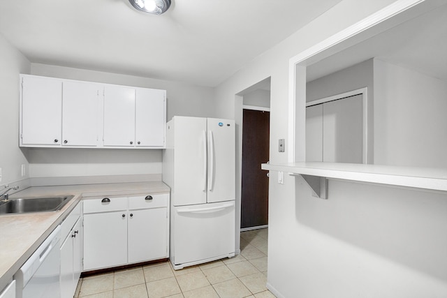 kitchen with white cabinetry, sink, white appliances, and light tile patterned floors