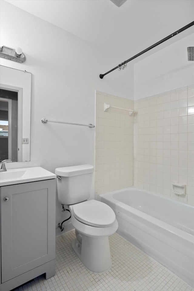 full bathroom with vanity, toilet, tile patterned flooring, and tiled shower / bath combo