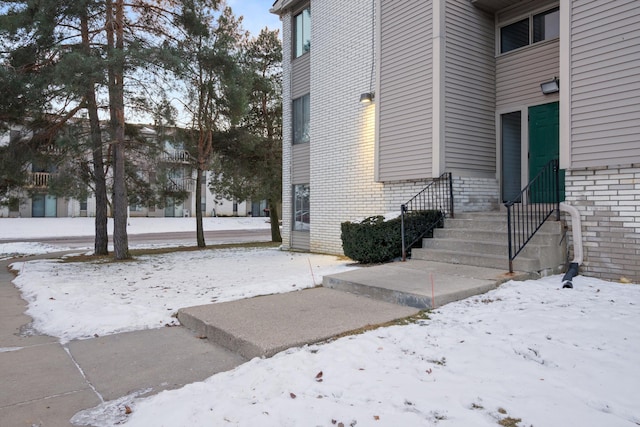 view of snow covered property entrance