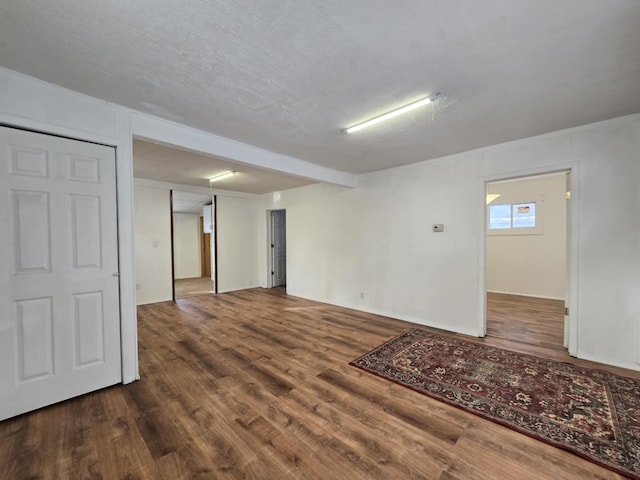 spare room featuring hardwood / wood-style floors and a textured ceiling