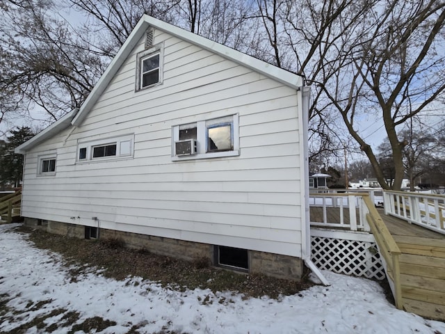 snow covered property featuring a wooden deck