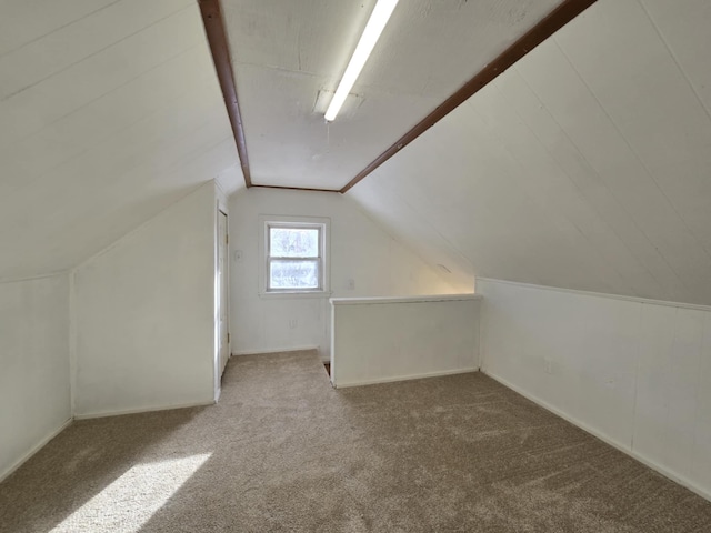 additional living space with carpet floors and vaulted ceiling