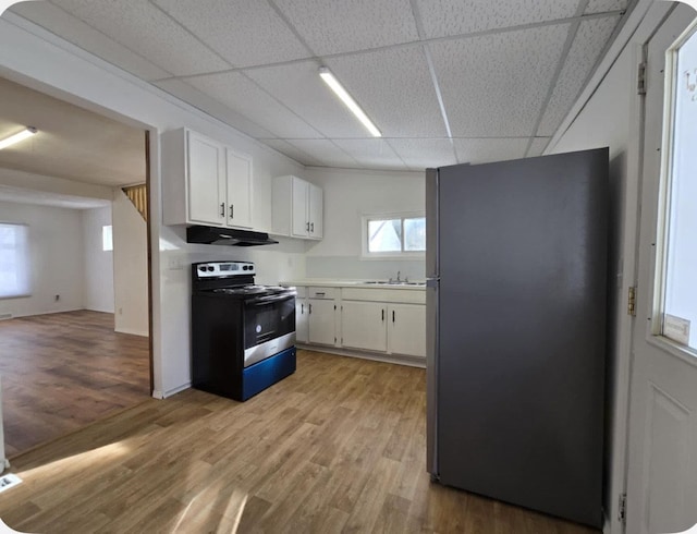 kitchen featuring sink, light wood-type flooring, a paneled ceiling, stainless steel appliances, and white cabinets