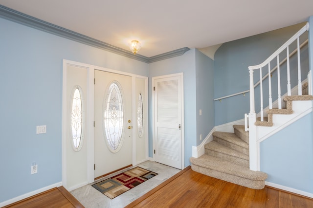 entrance foyer featuring ornamental molding and hardwood / wood-style floors