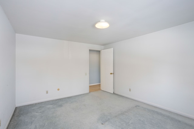 unfurnished room featuring light carpet