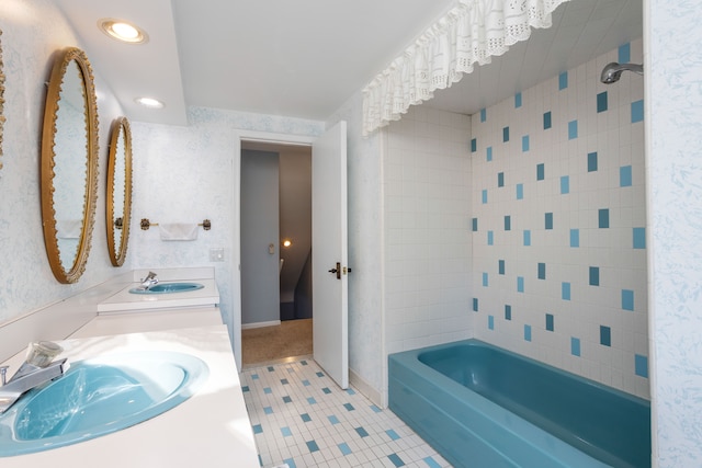 bathroom featuring tiled shower / bath, tile patterned flooring, and vanity