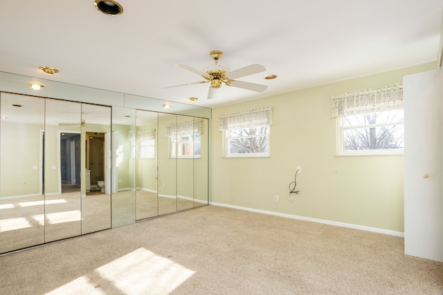 unfurnished bedroom with ceiling fan and carpet floors