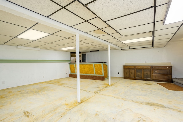 basement with a paneled ceiling