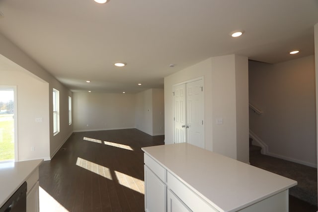 kitchen with dishwasher, white cabinets, a center island, and dark hardwood / wood-style flooring