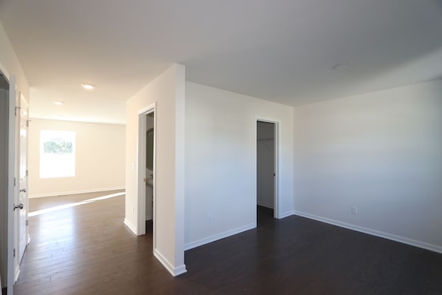 unfurnished room featuring dark wood-type flooring