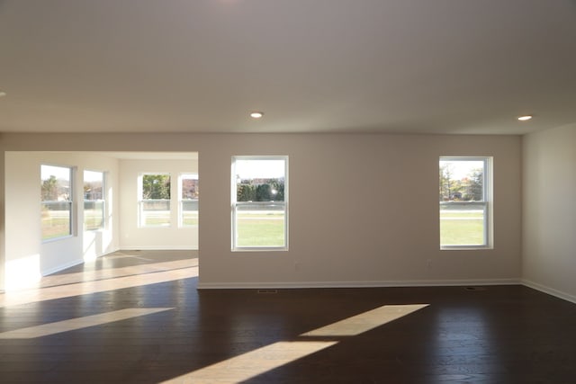 spare room with dark hardwood / wood-style floors