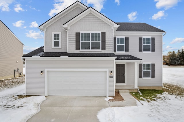 view of front of house with an attached garage, driveway, and roof with shingles