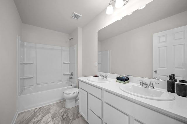 full bathroom featuring washtub / shower combination, vanity, and toilet