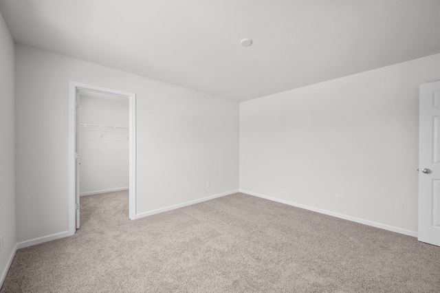 unfurnished room featuring light carpet