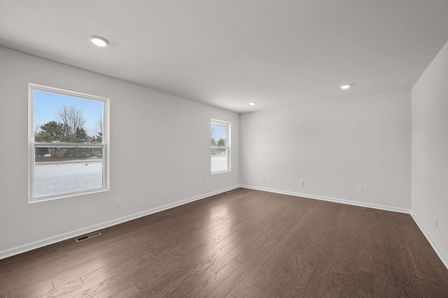 empty room featuring dark hardwood / wood-style flooring