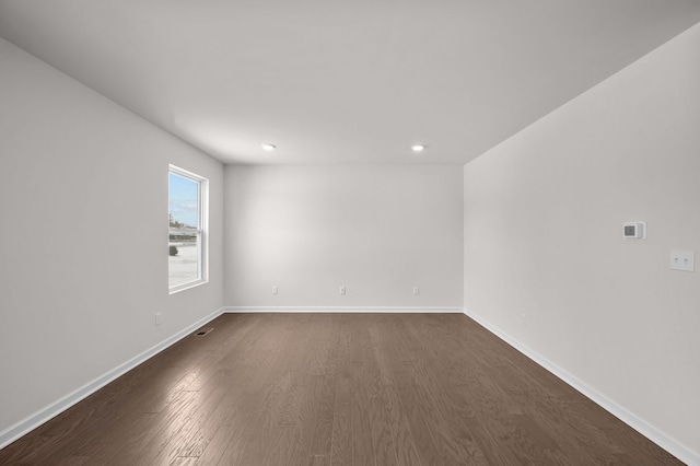 spare room featuring dark hardwood / wood-style floors