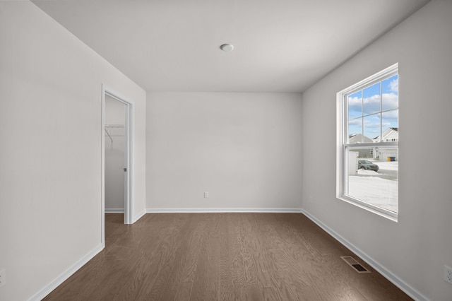 empty room featuring dark hardwood / wood-style flooring