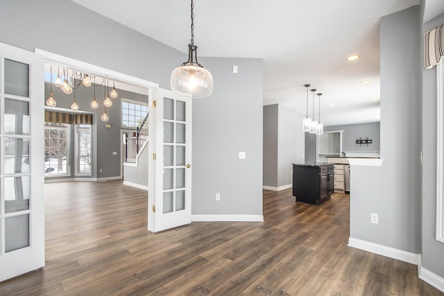 interior space with french doors, dark wood finished floors, and baseboards