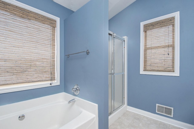 full bathroom with a stall shower, baseboards, visible vents, and a bath