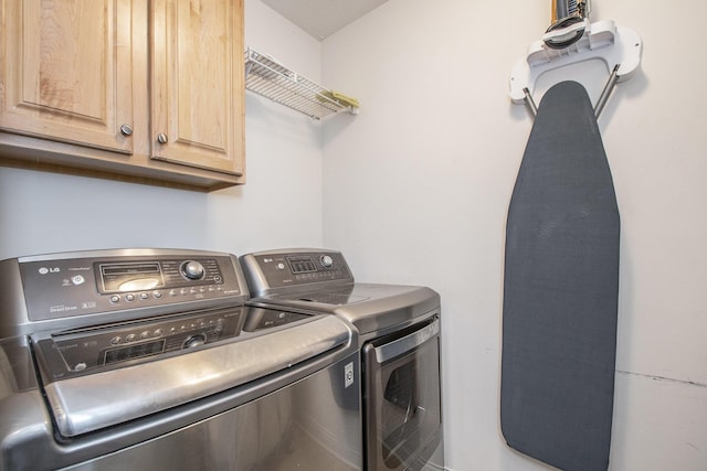 laundry area with cabinet space and separate washer and dryer