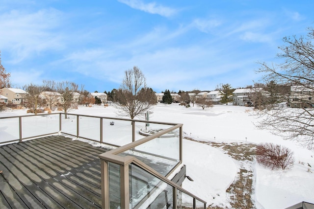 snow covered deck with a residential view